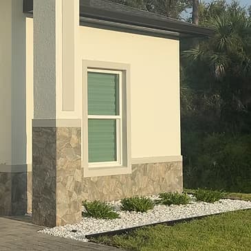 Decorative white marble chip landscape aggregate installation residential property Florida